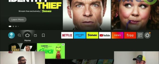 person holding firestick in front of tv