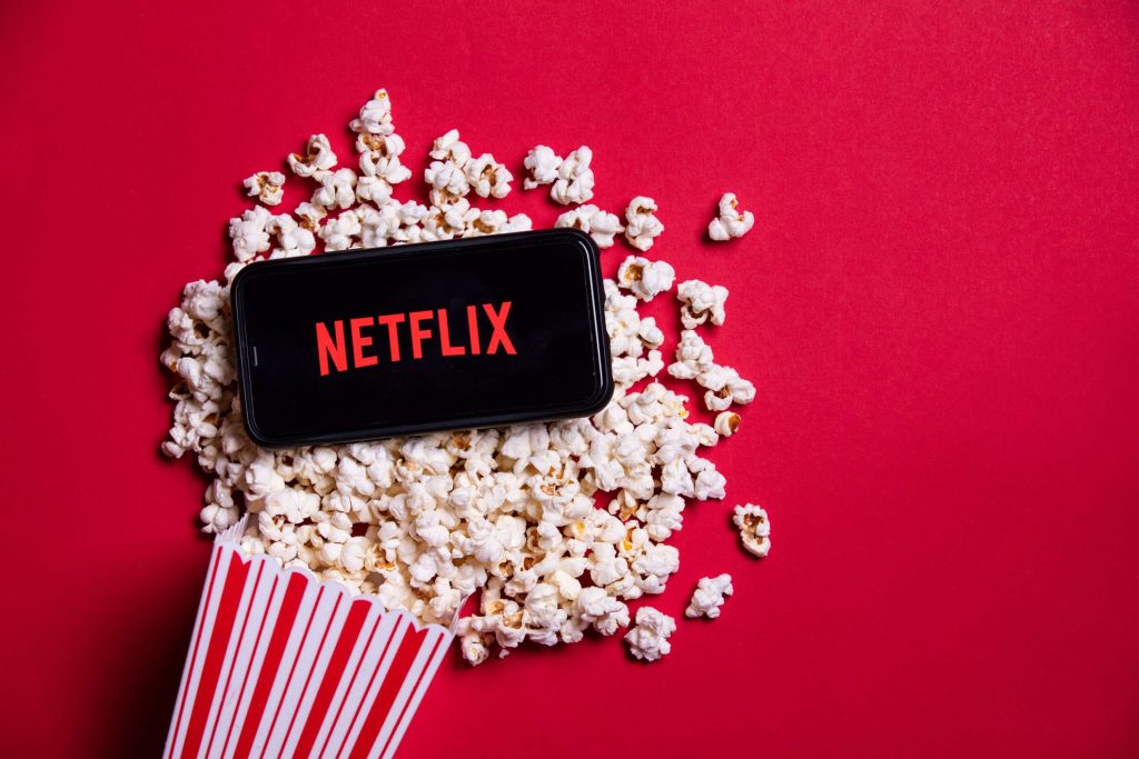 Photo of Netflix startup screen on mobile phone with popcorn