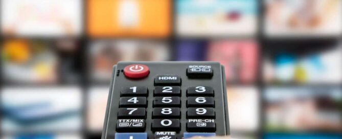 Person holding a remote pointed at a TV