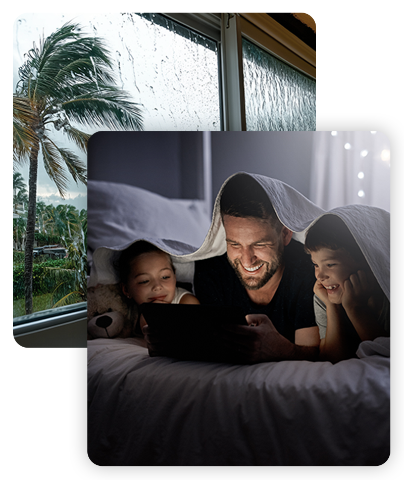 Florida storm outside and a young family comfortable using a tablet in bed