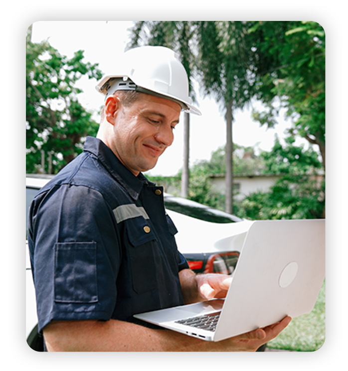 Career Benefits Field technician happily works on laptop at customer's home