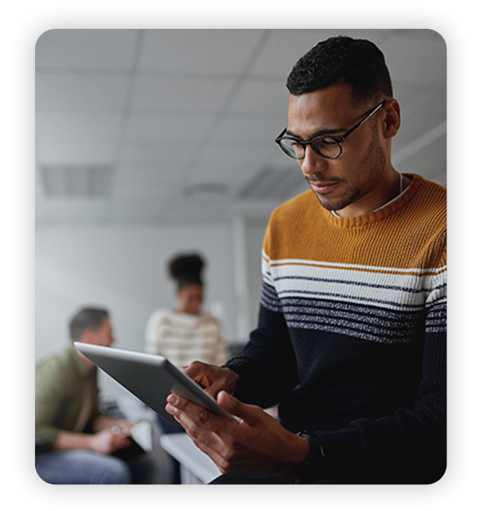 Careers_ Young man works with coworkers in modern office and modern tech