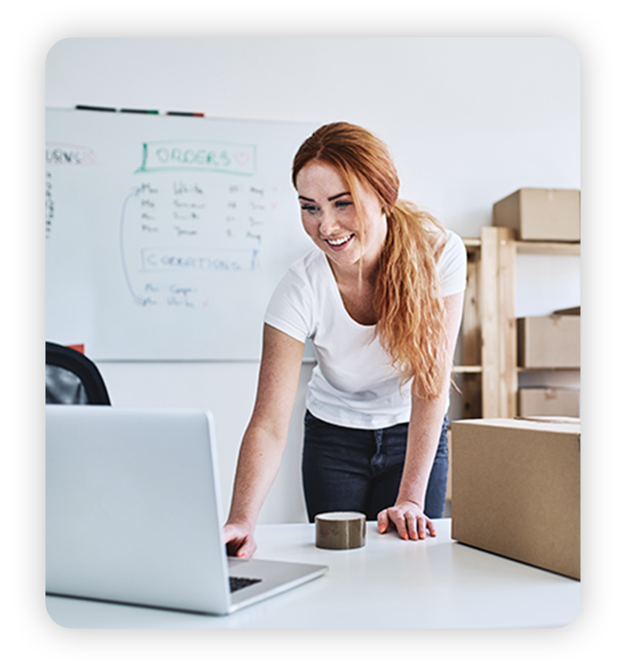 Young female business owner uses laptop to track orders