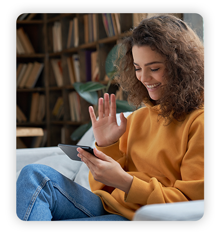 Young Latina woman uses phone at home to video call a friend