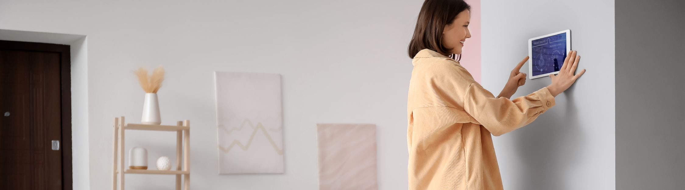 Woman uses wall-mounted security tablet